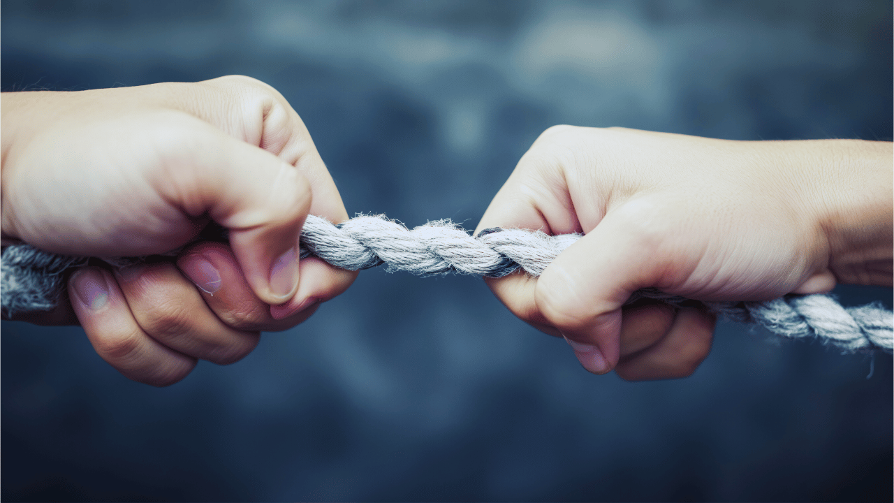 Two hands pulling a rope illustrating friction